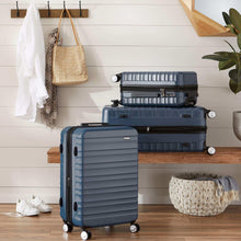 Navy polycarbonate spinner luggage open, showing interior divider and zip pockets