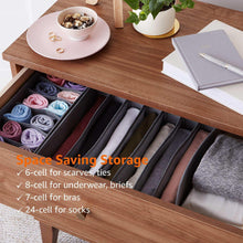 Gray fabric drawer organizer with multiple dividers holding folded socks, bras, and underwear