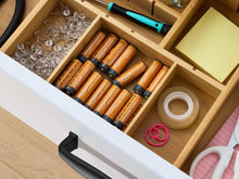 AA alkaline batteries stored in a wooden drawer compartment