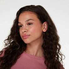Woman with subtle pink blush makeup look and glossy lips