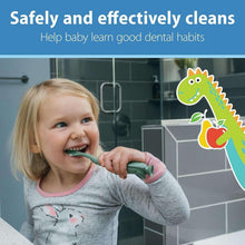 Toddler brushing with green training toothbrush and fluoride-free toothpaste