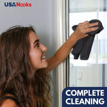 Microfiber cleaning cloth used to clean a window in a bright room