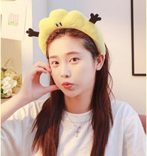 Yellow plush bunny-ear headband with black bows, worn during skincare routine