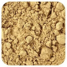Ground ginger powder texture, fine beige spice granules