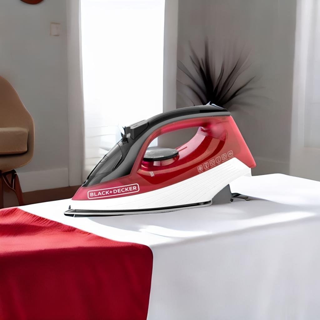Black+Decker red steam iron resting on an ironing board, soleplate facing down