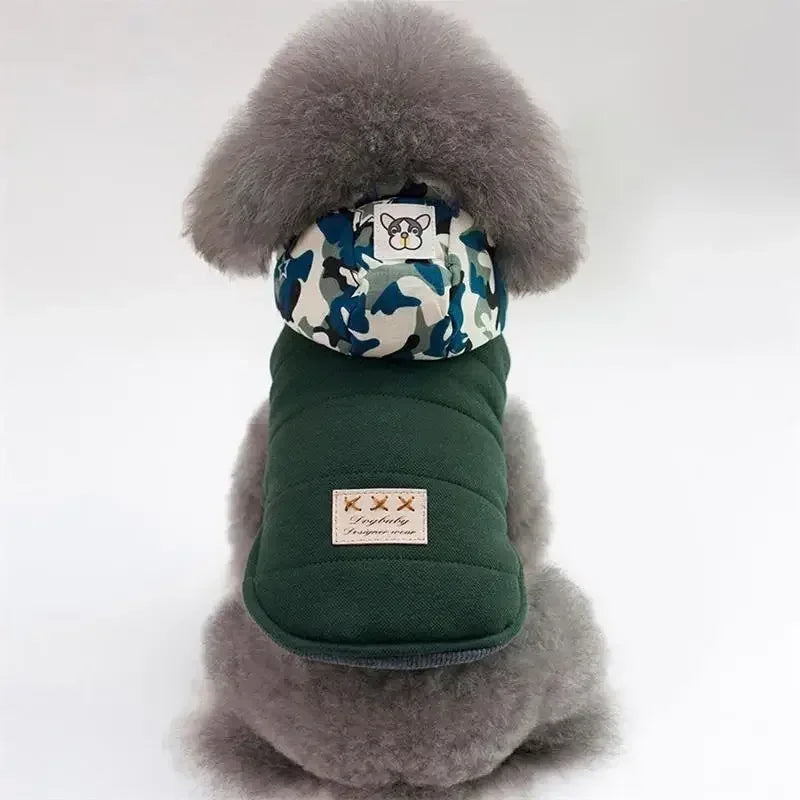 Green dog winter jacket with blue camo hood lining and white faux-fur trim.