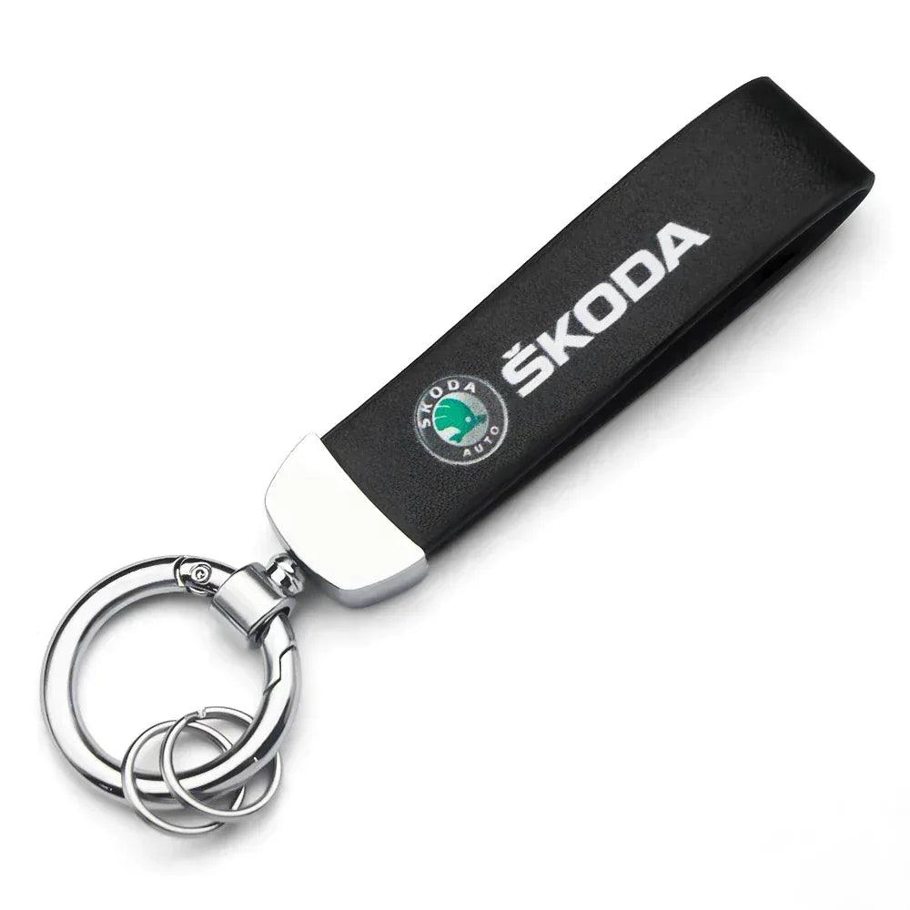 SKODA logo fabric keychain with black strap, silver clasp, and round keyring