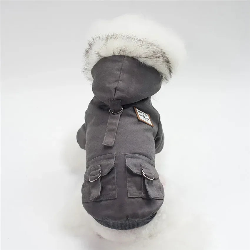 Dark gray dog parka with hood, front utility pockets, and white faux-fur trim.
