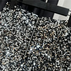 Silver sequined shorts close-up with front zipper and dense round sequin pattern