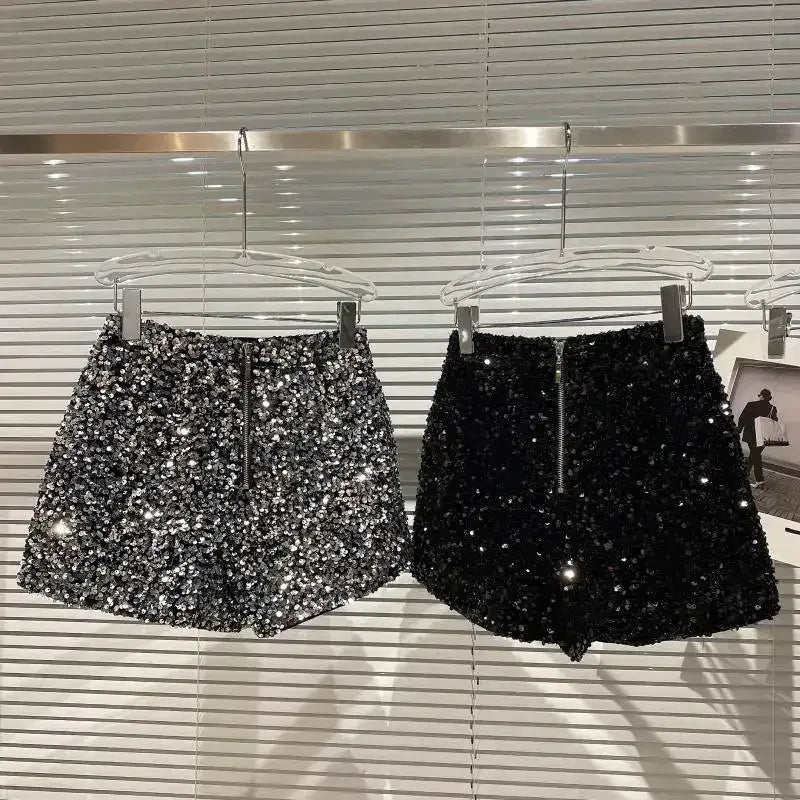 Silver and black sequin velvet shorts, both pairs front view on hangers