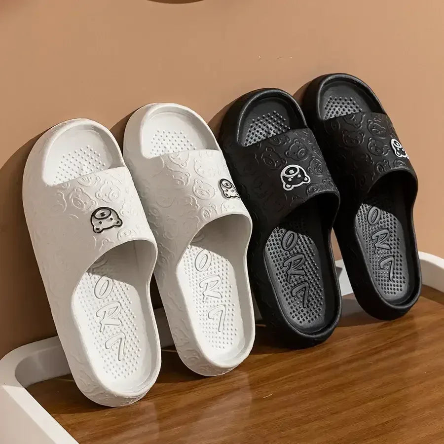 White and dark slide sandals with bear print and textured footbed