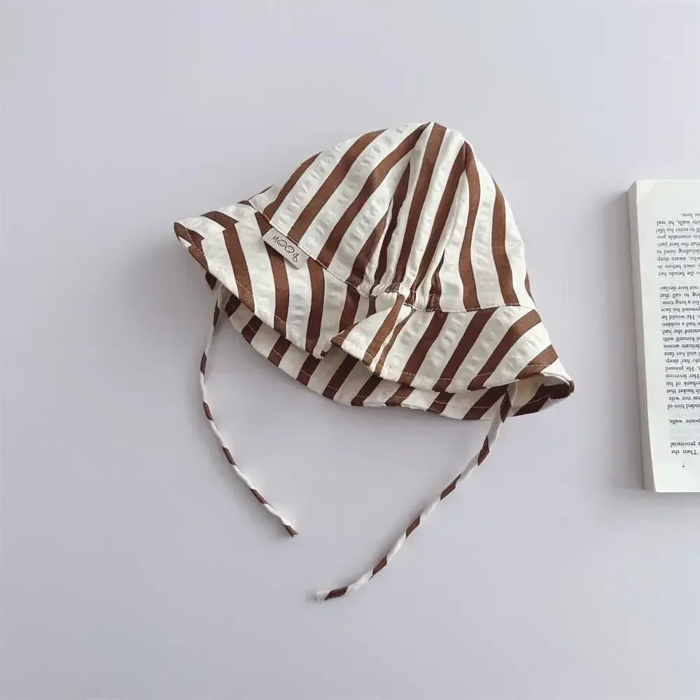 Brown-and-white striped lacing fisherman's cap with chin ties and curved brim