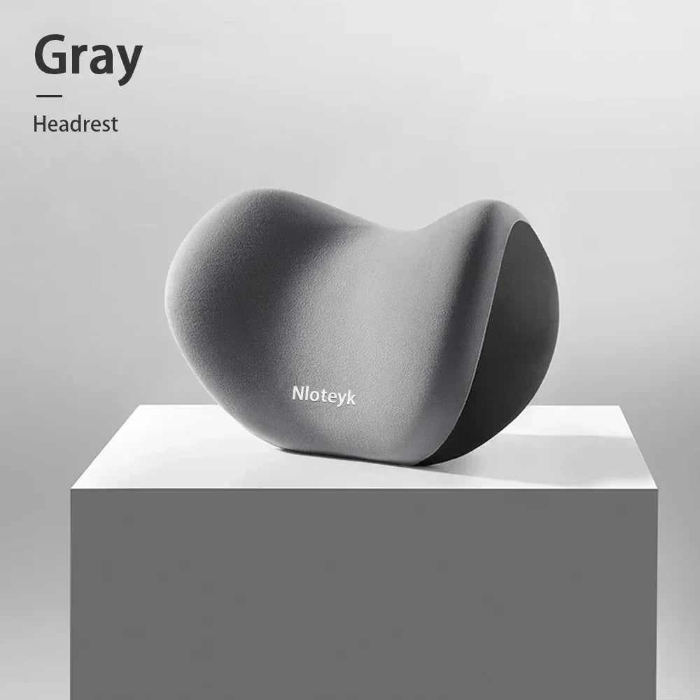 Gray ergonomic headrest cushion with contoured curved back
