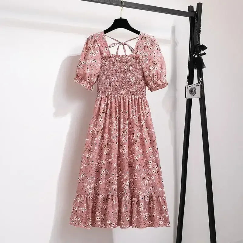 Pink ditsy floral A-line dress with smocked bodice, short puff sleeves, and elastic waist