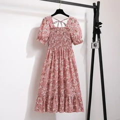 Pink ditsy floral A-line dress with smocked bodice, short puff sleeves, and elastic waist
