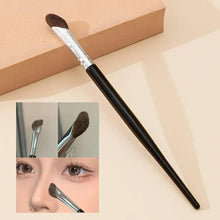 Angled contour nose makeup brush with brown bristles, silver ferrule, and black handle