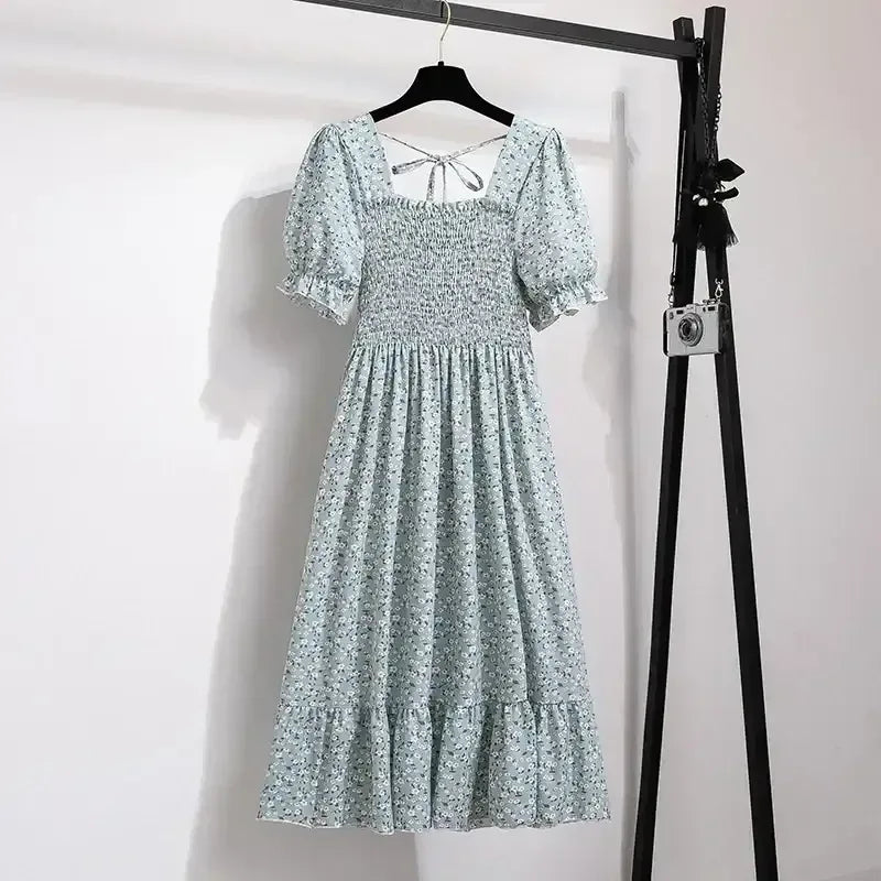 Light green ditsy floral A-line dress with smocked bodice, short puff sleeves, and elastic waist