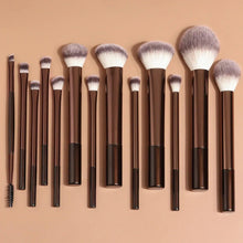 Makeup brush set with brown handles and dense white-and-gray bristles, assorted shapes