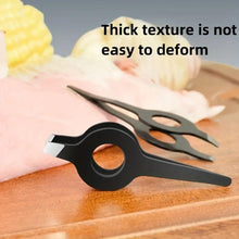 Black eyebrow tweezers plucking fine hair on skin surface