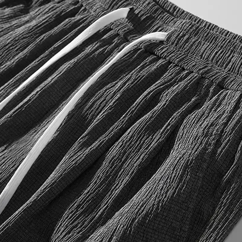 Silk shorts fabric close-up with textured black and gray striped pattern