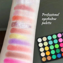 Eyeshadow palette with round pans beside pink and purple glittery swatches on skin