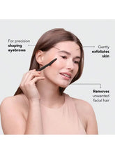 Eyebrow trimmer with black handle and silver blade, used on eyebrows