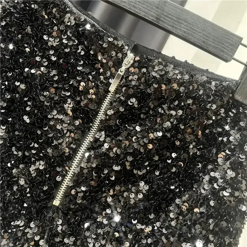 Black sequined shorts with front zipper detail and dense silver sequin sparkle