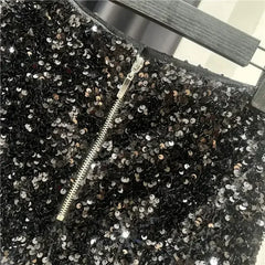 Black sequined shorts with front zipper detail and dense silver sequin sparkle
