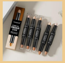 Concealer stick collection with black tubes and beige applicator tips in boxes