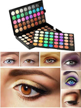 Eyeshadow palette open with many round pans and examples of colorful eye looks