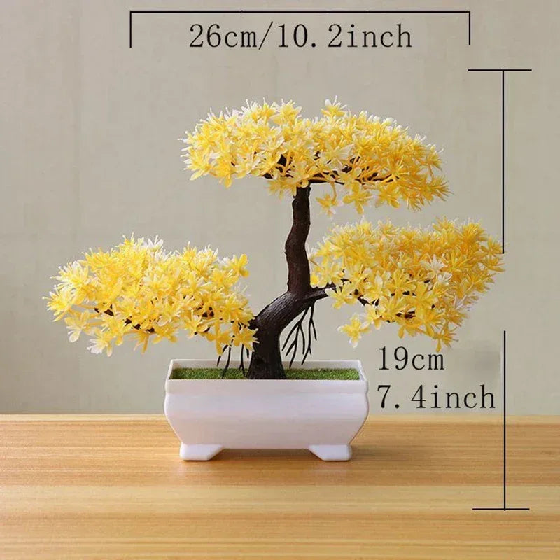 Artificial yellow bonsai tree with dark brown trunk in a white rectangular pot.