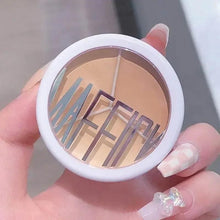 Concealer palette compact held in hand, showing circular three-tone pans