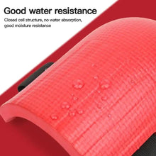 Pink knee pad surface with water droplets and black side strap.