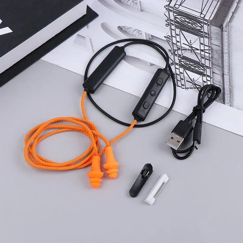 Orange wired Bluetooth headset earplugs with black inline controller and USB charging cable