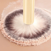 Powder makeup brush with cream handle applying product from a thick round bristle head