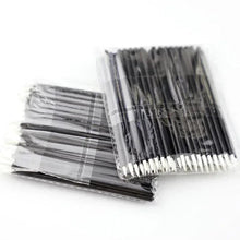 Disposable lip applicator brushes in clear bags, dark handles, white bristles