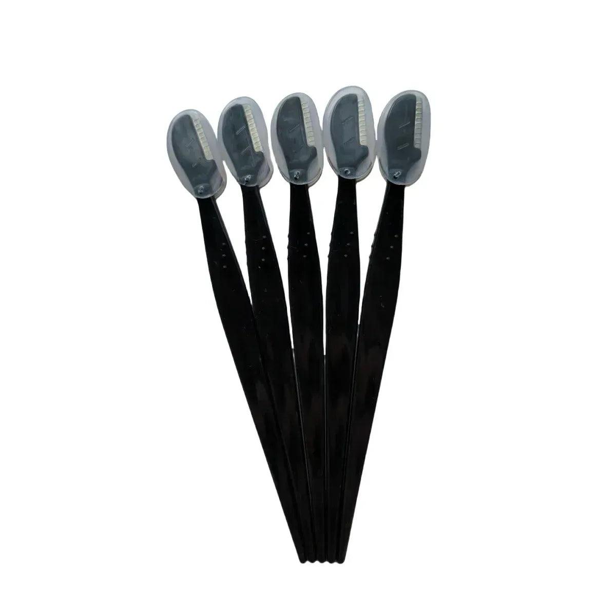 Set of disposable eyebrow trimmers with black handles and curved blade covers