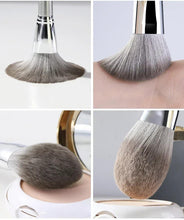 Powder makeup brush with silver handle and gray bristles, close-up