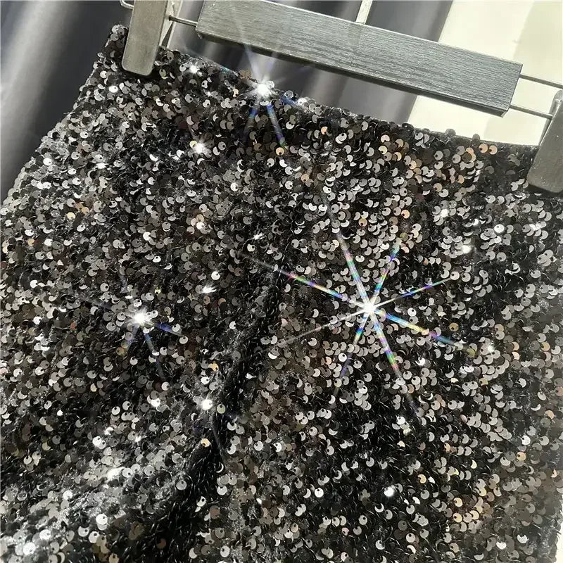 Black sequined shorts with shiny silver all-over sparkle and front zip fly
