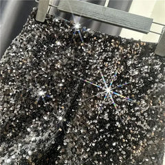 Black sequined shorts with shiny silver all-over sparkle and front zip fly