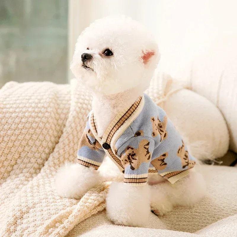 Light blue dog cardigan sweater with animal print and tan ribbed trim