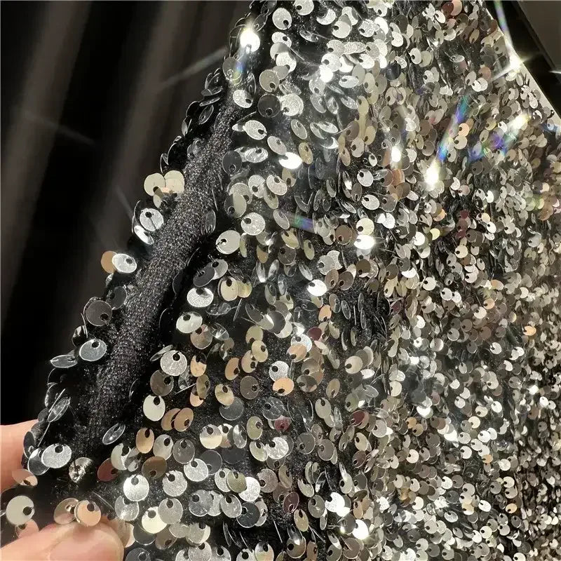Silver-tone sequined shorts close-up with dense round sequins and glittery finish