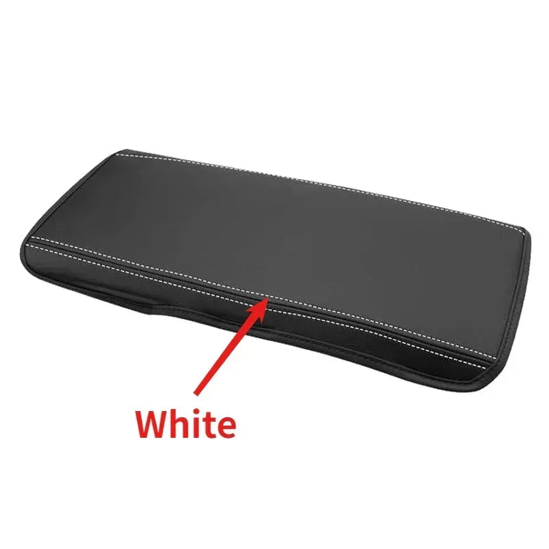 Center console armrest cover with white edge stitching detail, smooth dark pad