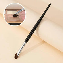 Angled makeup brush with brown bristles and silver ferrule on a black handle