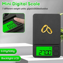 Mini digital pocket scale with green backlit LCD weighing a small gold ring