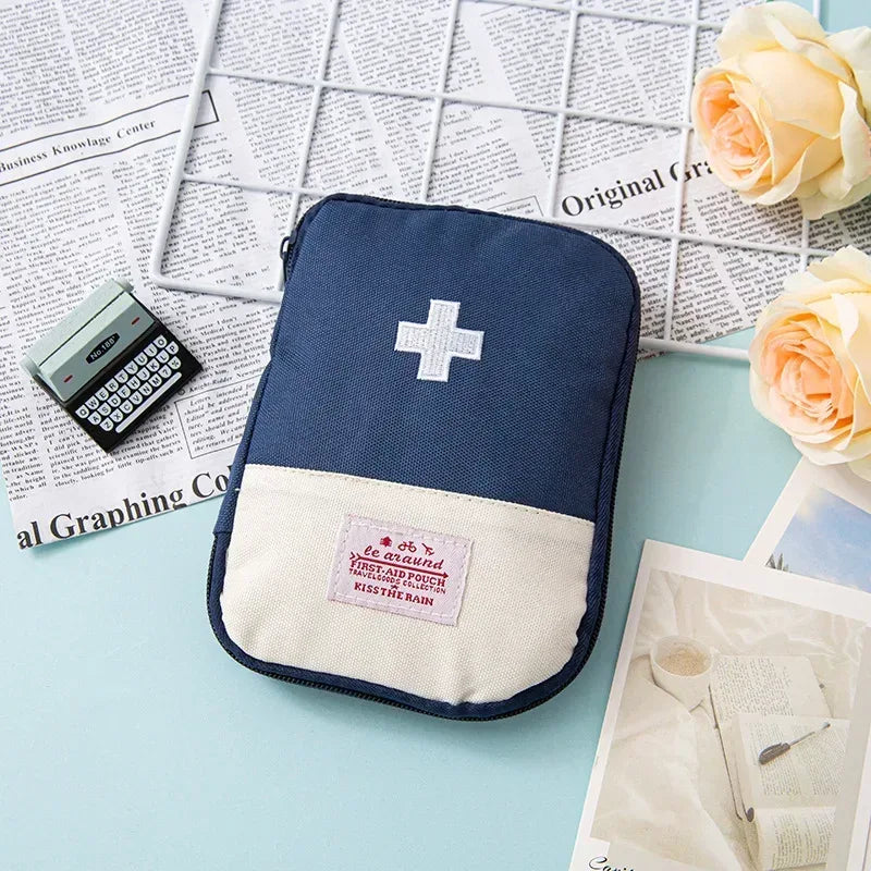Blue mini medicine bag with white cross patch and zipper closure front pocket label