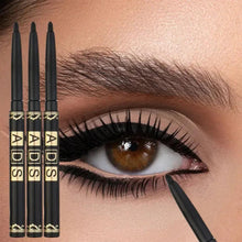 Close-up eye makeup with black eyeliner pencil tip; three pencils lined up left