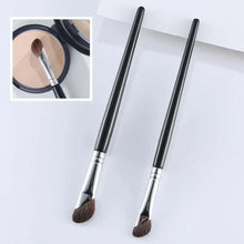 Two angled makeup brushes with brown bristles, silver ferrules, and black handles