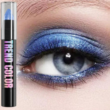 Blue pearlescent glitter eyeshadow pencil with shimmer applicator, shown swatched on an eye.