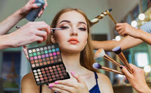 Cosmetic makeup palette with many round eyeshadow pans held during application